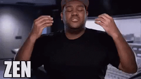 A Man With His Eyes Closed Is Wearing A Black Shirt And A Hat And The Word Zen Is On The Bottom Right GIF