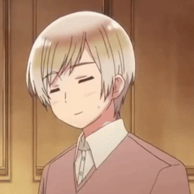 A Man With His Eyes Closed Is Wearing A Pink Sweater And White Shirt GIF