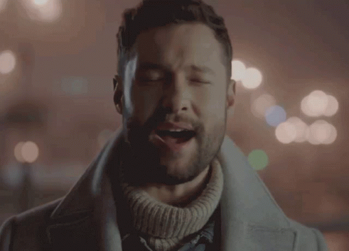 A Man With His Eyes Closed Is Wearing A Sweater GIF