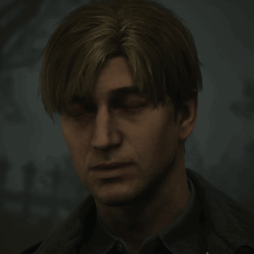 a man with his eyes closed looks down at something