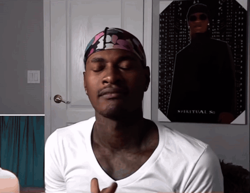 A Man With His Eyes Closed Stands In Front Of A Poster That Says Spiritual So GIF