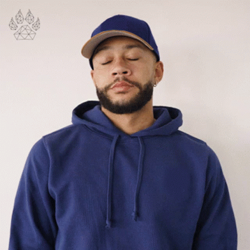 A Man With His Eyes Closed Wears A Blue Hoodie GIF