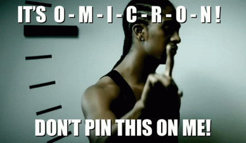 a man with his finger on his lips and the words " it 's o-m-i-c-r-o-n ! "