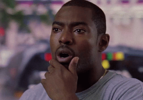 A Man With His Hand On His Chin And His Mouth Open GIF