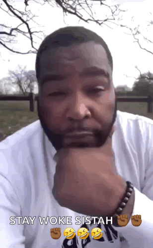 A Man With His Hand On His Chin And The Words Stay Woke Sitah GIF