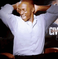 A Man With His Hands Behind His Head Is Wearing A Shirt That Says Civ GIF