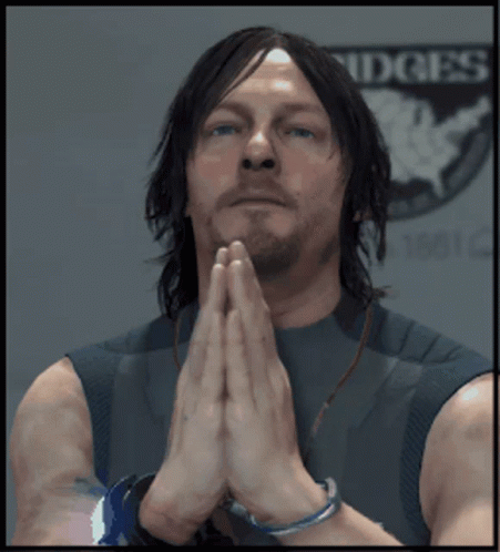 A Man With His Hands Folded Praying In Front Of A Sign That Says Ridges GIF