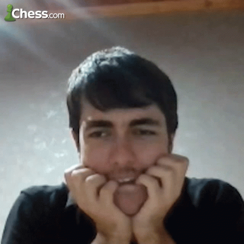 A Man With His Hands On His Face With Chess.com In The Background GIF