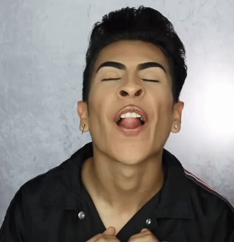 A Man With His Mouth Open And His Tongue Sticking Out GIF