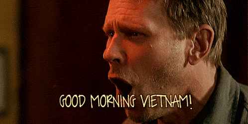 A Man With His Mouth Open And The Words Good Morning Vietnam Written Below Him GIF