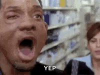 A Man With His Mouth Open In A Store With A Woman Behind Him . GIF