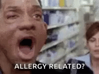 A Man With His Mouth Open Is Saying `` Allergy Related ? '' In A Grocery Store . GIF