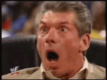 A Man With His Mouth Open Is Sitting In A Chair . GIF