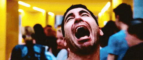 A Man With His Mouth Wide Open Is Surrounded By People GIF