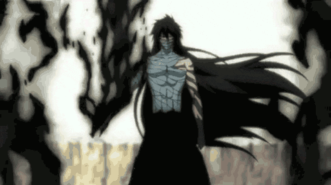 A Man With Long Black Hair And A Mask On His Face Is Standing In A Dark Room . GIF