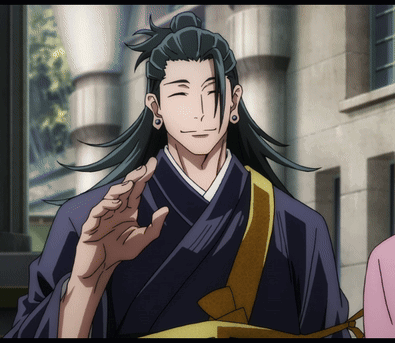 A Man With Long Black Hair And A Ponytail Is Smiling GIF