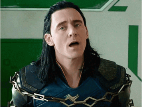 A Man With Long Black Hair Is Chained To A Wall With His Mouth Open . GIF