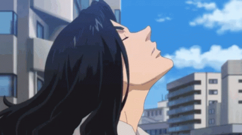A Man With Long Black Hair Is Looking Up Into The Sky GIF
