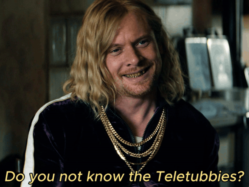 A Man With Long Blonde Hair And A Beard Is Smiling With The Words Do You Not Know The Teletubbies Below Him GIF
