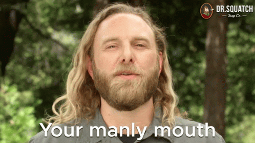 A Man With Long Blonde Hair And A Beard Says Your Manly Mouth GIF