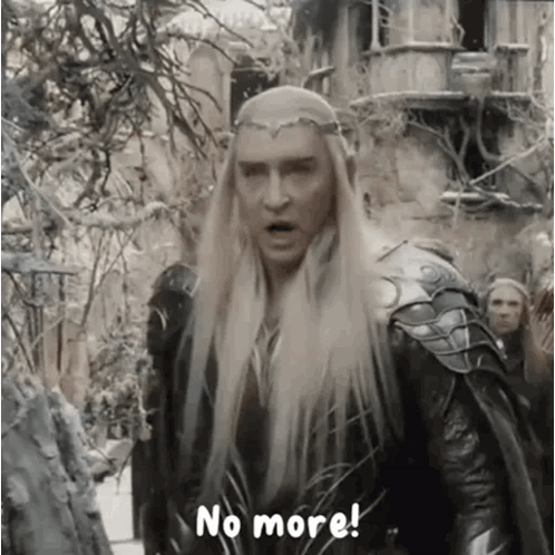 a man with long blonde hair and a crown on his head is standing in front of a group of people .