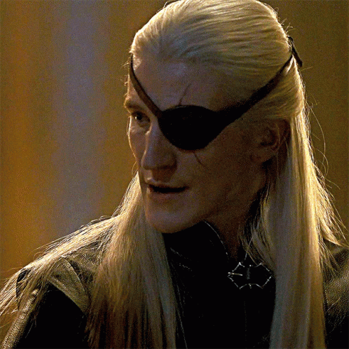 A Man With Long Blonde Hair And An Eye Patch On His Eye GIF