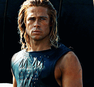 A Man With Long Blonde Hair Is Wearing A Black Leather Vest GIF