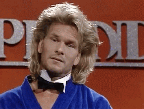A Man With Long Blonde Hair Is Wearing A Bow Tie And A Blue Robe GIF
