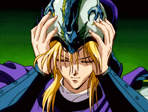 A Man With Long Blonde Hair Is Wearing A Helmet With A Dragon Design On It GIF