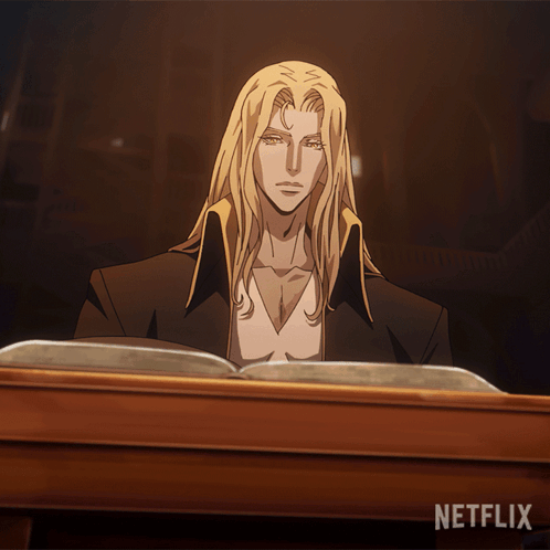 A Man With Long Blonde Hair Sits At A Table Reading A Book With Netflix Written On The Bottom GIF