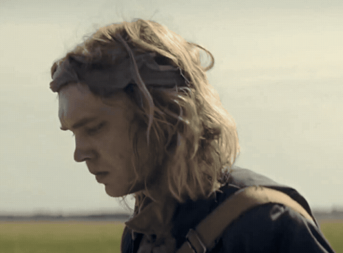 A Man With Long Blonde Hair Wearing A Helmet GIF