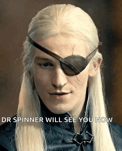 A Man With Long Blonde Hair Wearing An Eye Patch With The Words " Your Spinner Will See You Now " Below Him GIF