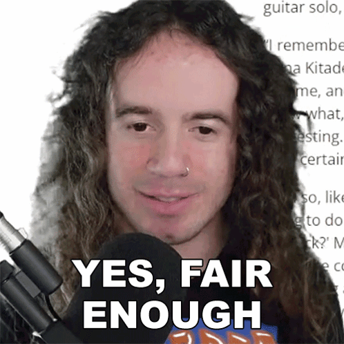 A Man With Long Curly Hair Is Smiling And Says Yes Fair Enough GIF