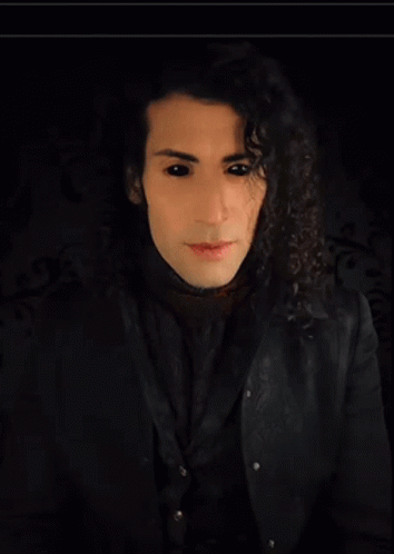 Man With Long Curly Hair In Black Shirt GIF