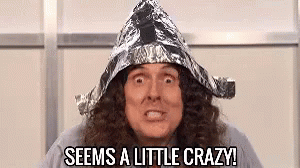 A Man With Long Curly Hair Is Wearing A Tin Foil Hat And Saying `` Seems A Little Crazy '' . GIF