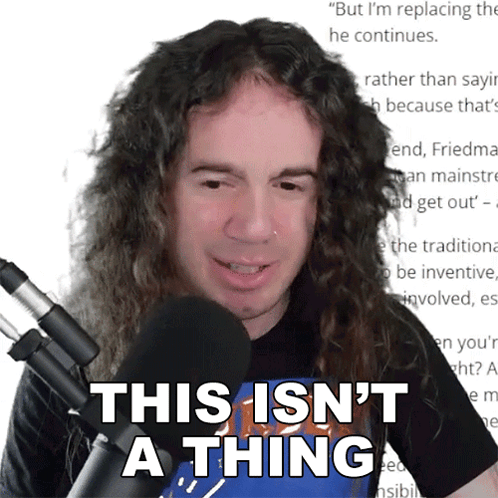 A Man With Long Curly Hair Stands In Front Of A Microphone And Says This Isn 'T A Thing GIF