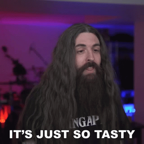 A Man With Long Hair And A Beard Has The Word So Tasty Above Him GIF