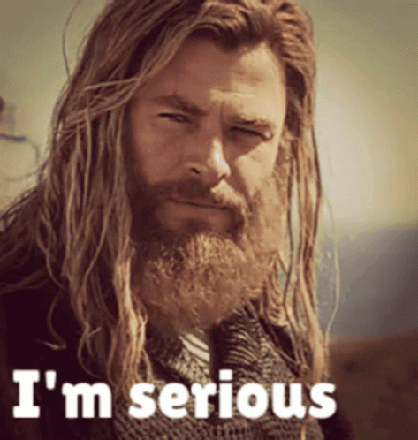 A Man With Long Hair And A Beard Has The Words I 'M Serious On His Face GIF