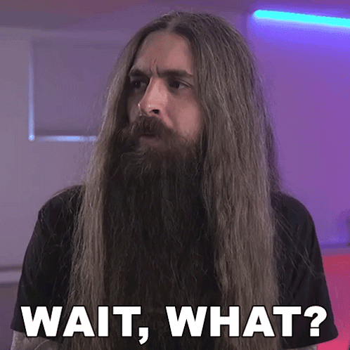 A Man With Long Hair And A Beard Has The Words Wait What Written Below Him GIF