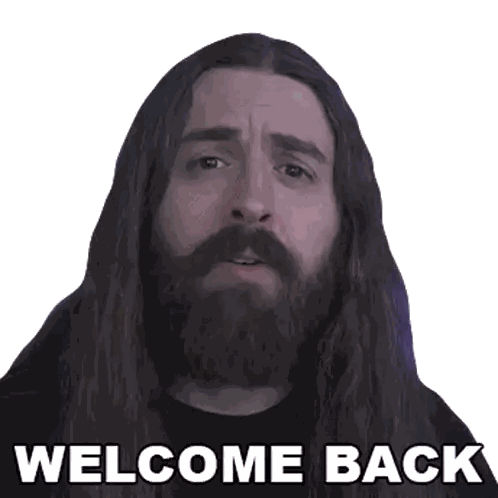a man with long hair and a beard has the words welcome back on his face