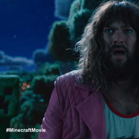 A Man With Long Hair And A Beard In A Pink Jacket GIF