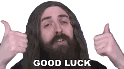 a man with long hair and a beard is giving two thumbs up with the words good luck written below him