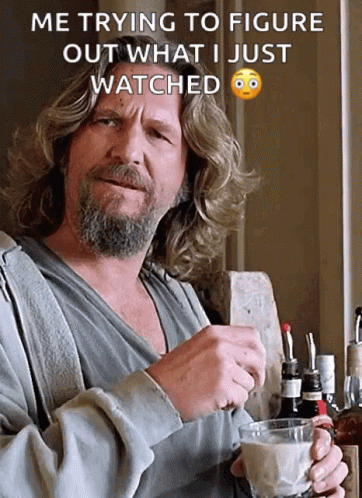 A Man With Long Hair And A Beard Is Holding A Cup Of Coffee And A Bottle Of Whiskey In His Hand GIF