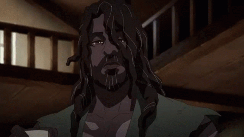 A Man With Long Hair And A Beard Is Holding A Piece Of Paper In His Hands . GIF