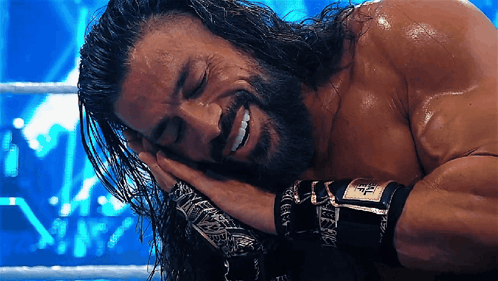 A Man With Long Hair And A Beard Is Laying Down With His Eyes Closed GIF