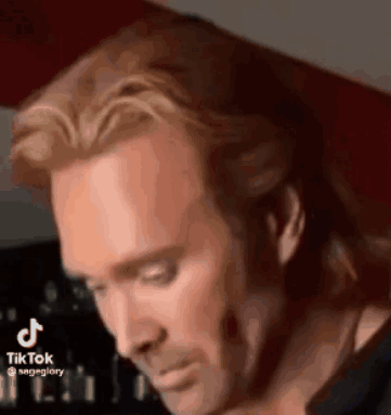Man With Long Hair And Beard Looking Down GIF