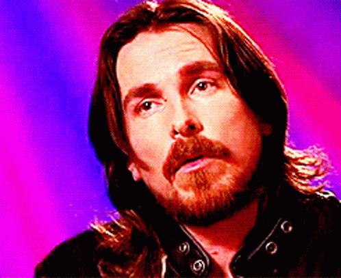 A Man With Long Hair And A Beard Is Looking Up GIF