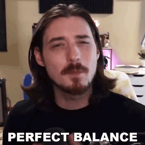 A Man With Long Hair And A Beard Is Making A Funny Face And Saying `` Perfect Balance '' . GIF