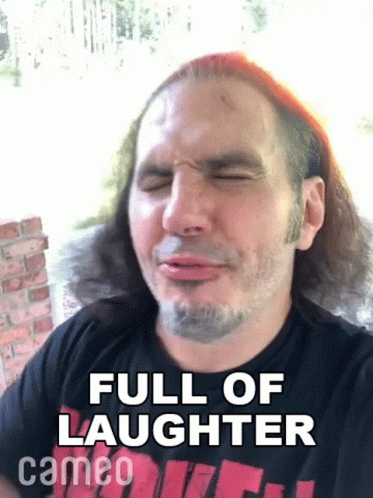A Man With Long Hair And A Beard Is Making A Funny Face And Says Full Of Laughter Cameo On The Bottom . GIF