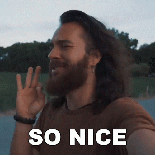 A Man With Long Hair And A Beard Is Making A Peace Sign With The Words So Nice Behind Him GIF